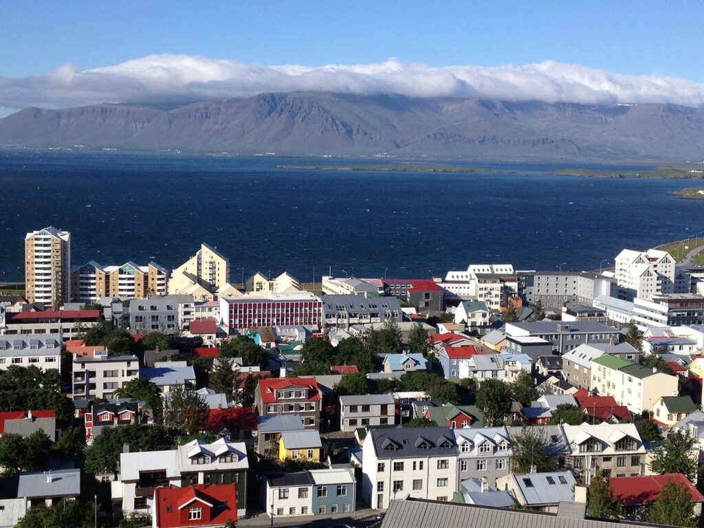 Scenic view of Reykjavik, Iceland, showcasing the picturesque town with colorful buildings, surrounded by natural beauty.